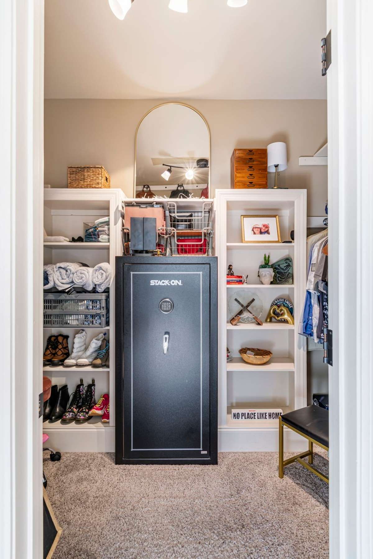 Built-in shelving and safe in primary closet.