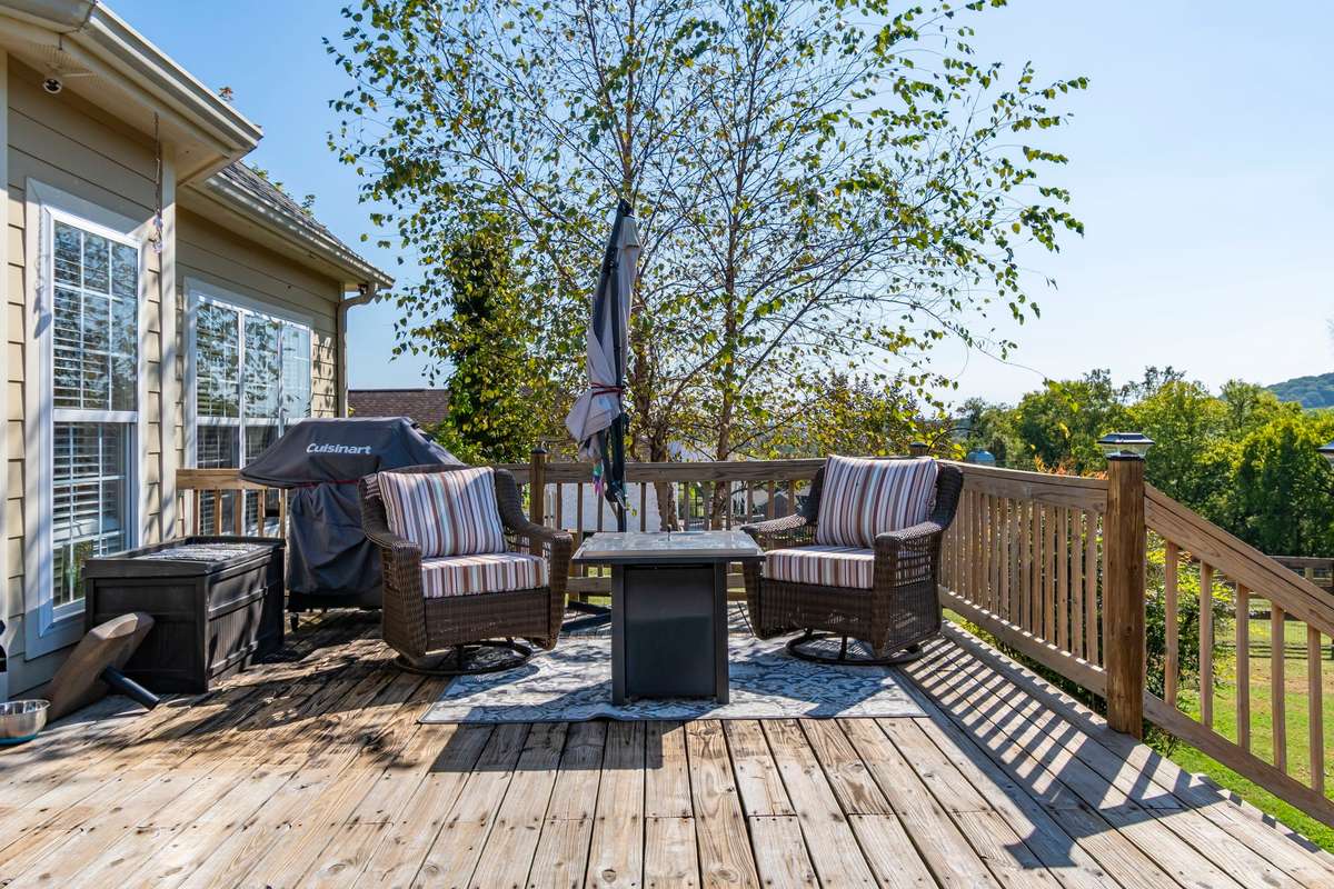 Maturing trees border the deck.