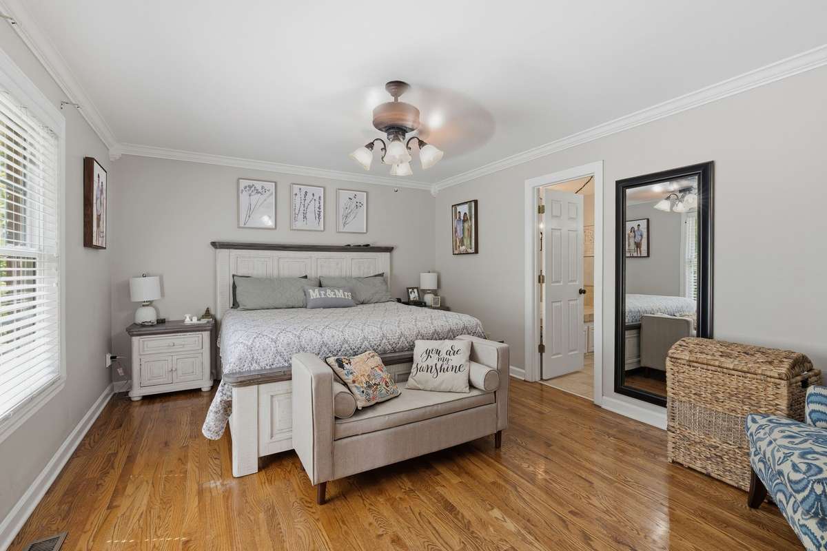 NOW WE ARE AT THE PRIMARY OR MASTER BEDROOM - VERY LARGE AND ACCOMMODATING LOTS OF PIECES.  WOOD FLOORING IS BEAUTIFUL
