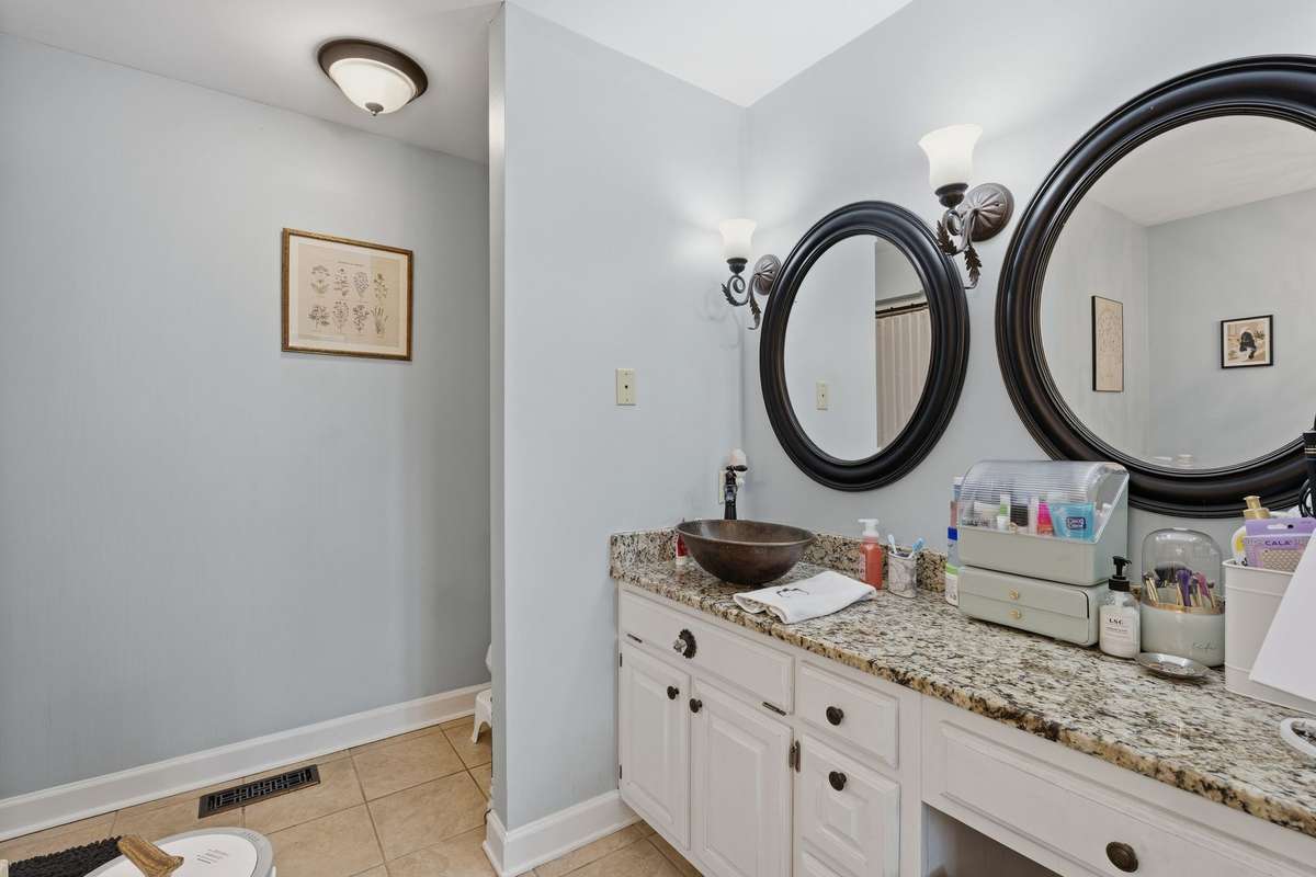 AND THE DOUBLE VANITY IS EQUALLY AS CHARMING AS THE REST OF THE HOME.
