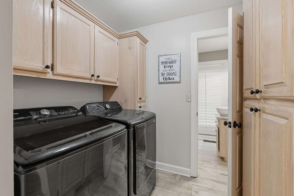 THE LAUNDRY AREA IS CLEVERLY OUT OF THE WAY, YET HANDY.