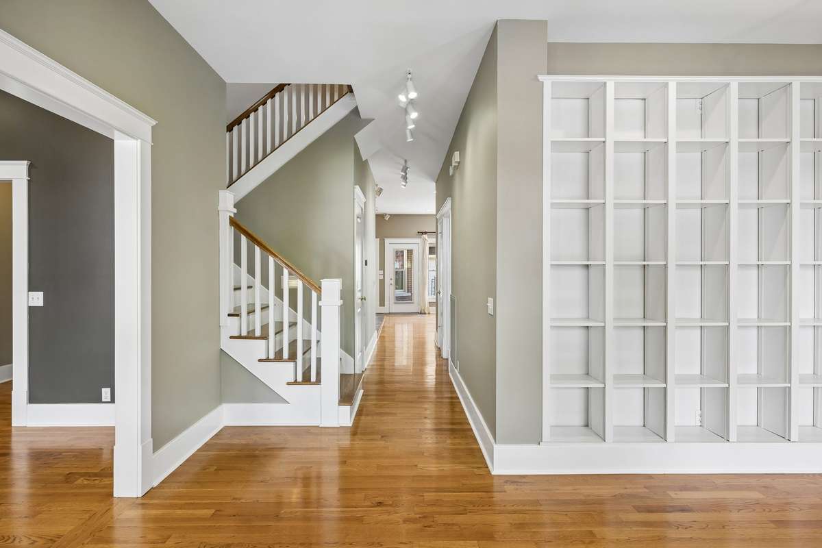 You are greeted by the custom built in bookshelves in the formal living room as you enter the front door