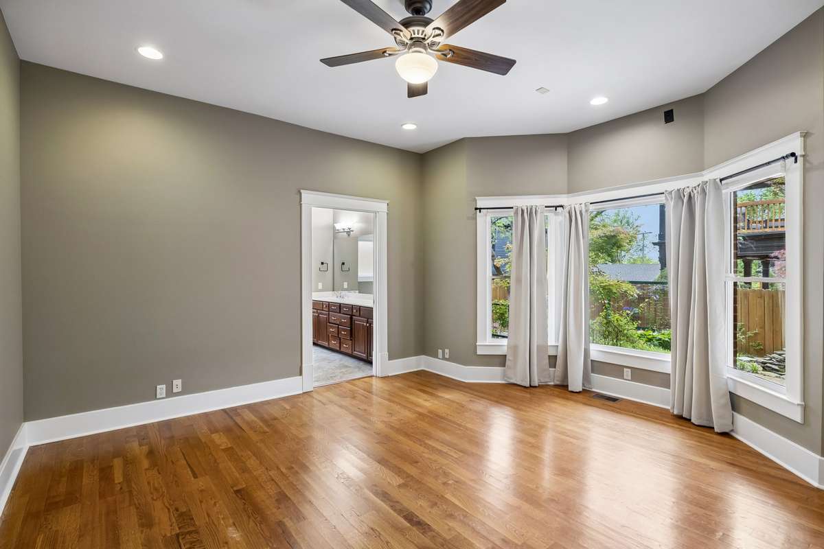 Main-level primary bedroom with views of the covered back porch