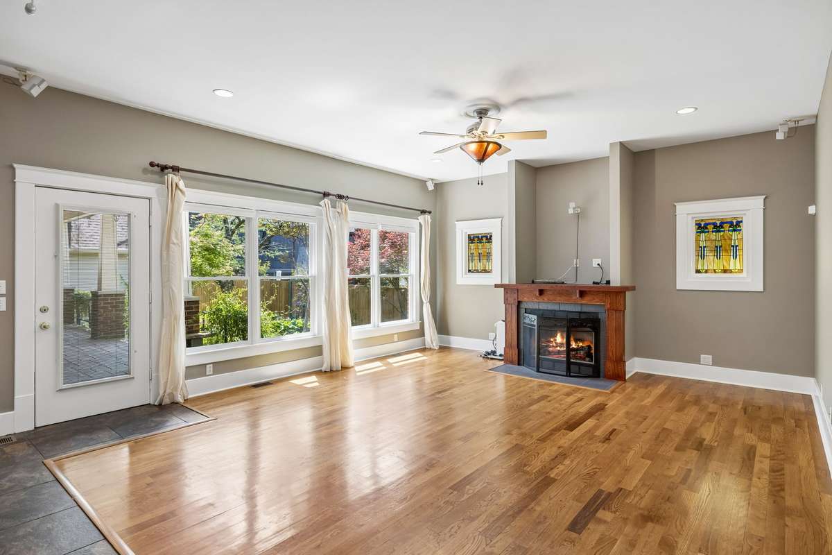 Light-filled family room that flows seamlessly into the kitchen, centered around a cozy fireplace perfect for everyday living and entertaining