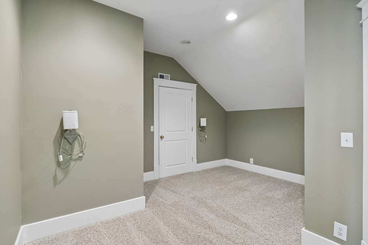 Upstairs third bedroom featuring a spacious closet and convenient access to walk-in attic storage