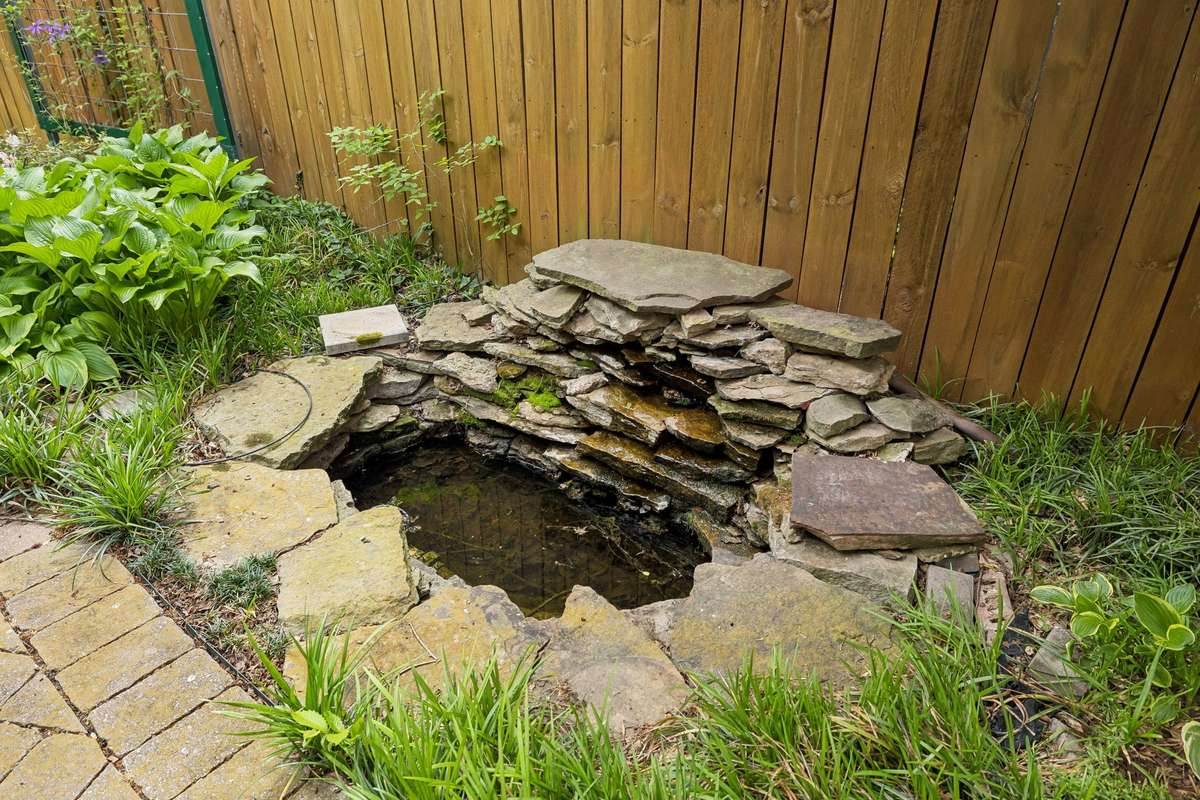 Relaxing backyard retreat with a functional waterfall feature, creating a peaceful outdoor setting!