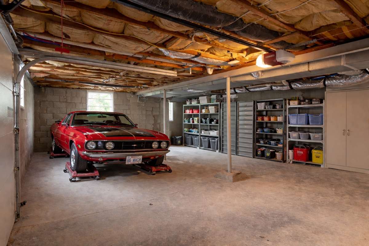 This garage is 700 sqft! Multiple cars can fit in & still leave a tremendous amount of storage space. Maybe you would want to finish out some or all of it to add more square footage! (**picture was ai enhanced to show the way the home could live**)