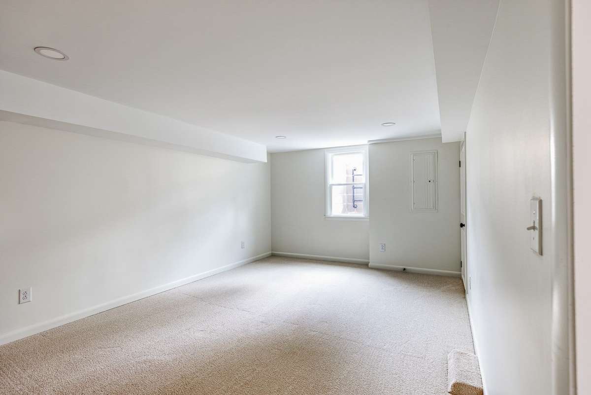 Non ai enhanced photo of the downstairs secondary bedroom (has en-suite bathroom).