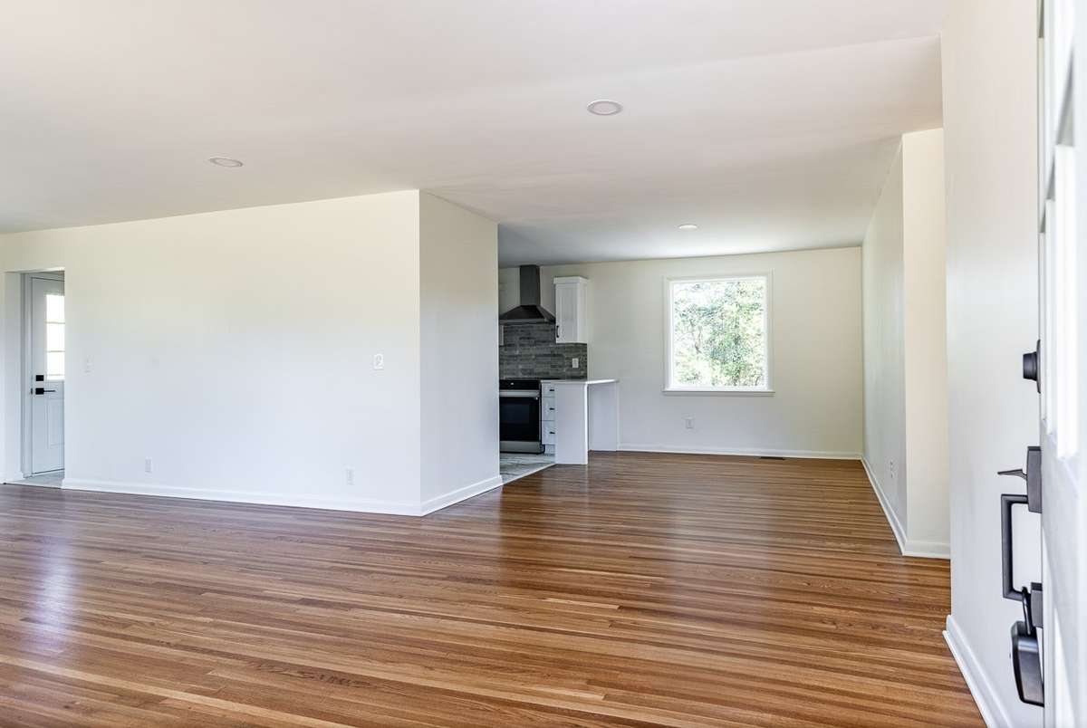 Non enhanced photo entering the home. Dining and living room open to the kitchen.