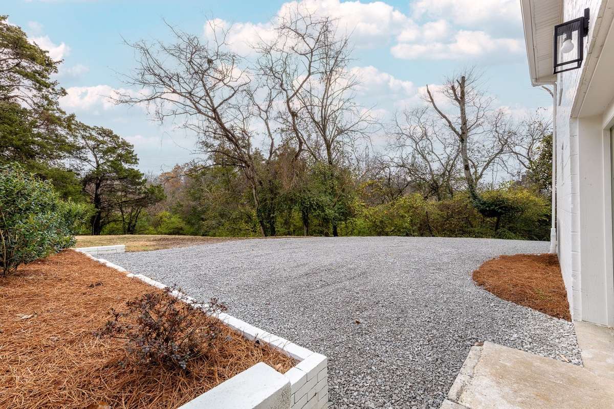 Fresh new driveway and trees all around.