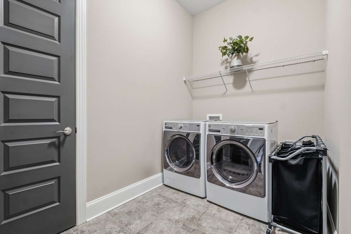 First floor laundry located next to the owners suite with tile floors and a closet for all your cleaning storage needs. Washer and Dryer remains.