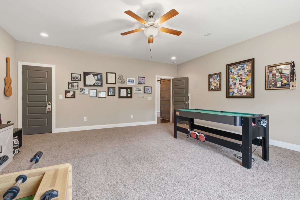 Huge Media Room/Bonus Room with enough room for seating and games both!  There is a large walk in closet and a full door access to the walk in attic.
