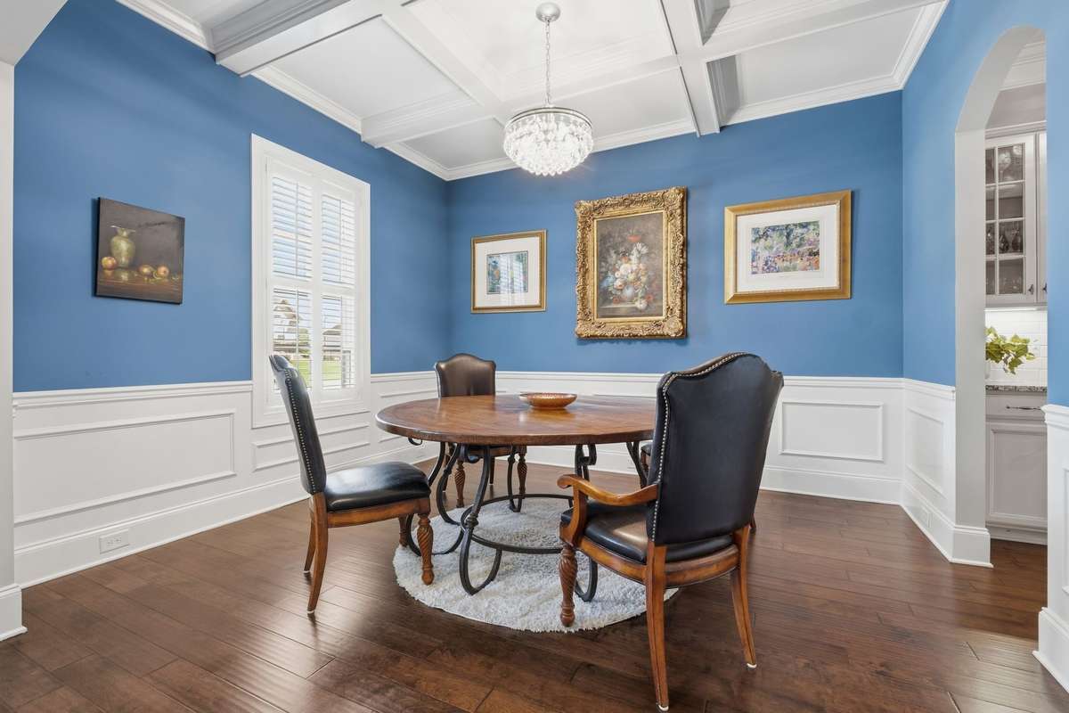 Formal dining Room located just off the foyer with Custom trimmed ceiling, finished wood floors and Wainscoting.