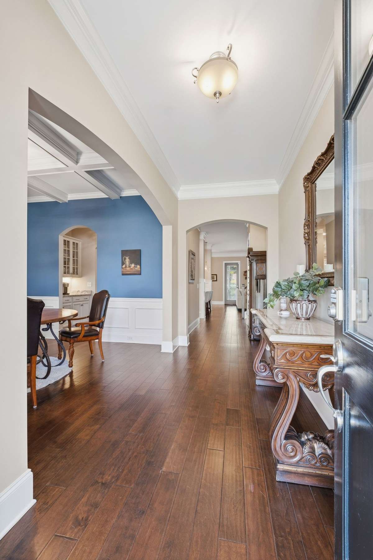 Large Entry Foyer with finished Wood Floors and Wooden front door - Light and Bright!