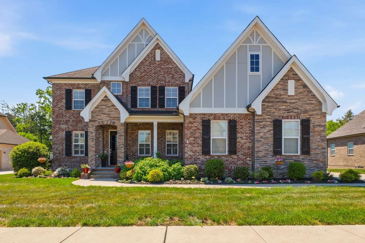 Full Brick Home with Batten Board  and Stone Accents.  Located on a level lot with Wooded common area behind the home for Privacy.