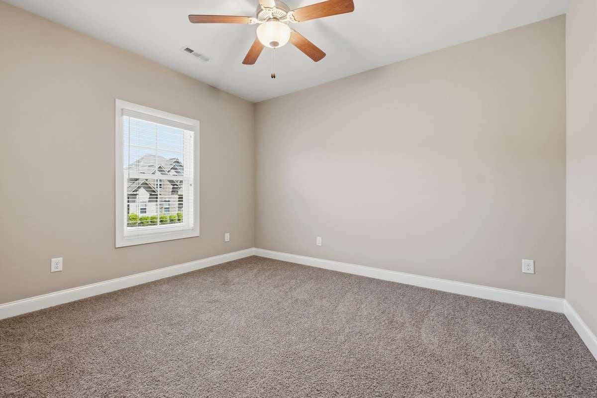 Bedroom 4 features a ceiling fan and large walk-in closet with neutral floors and walls.