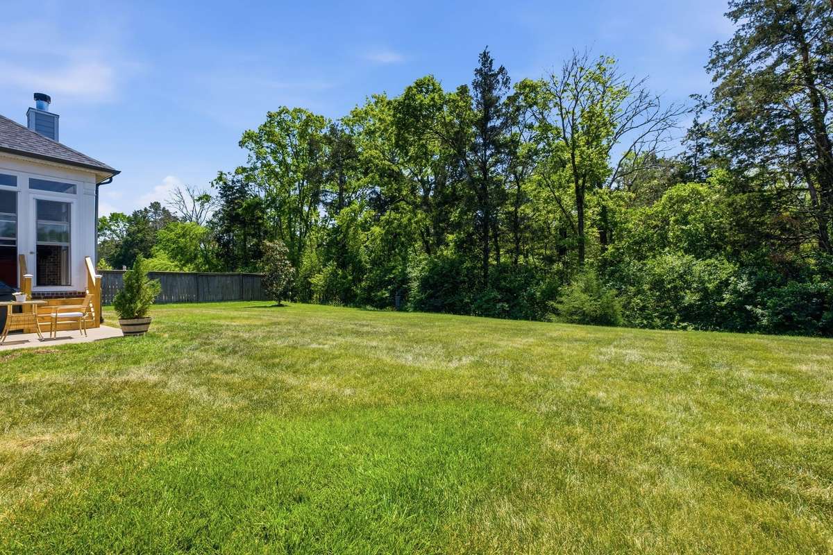 Privacy with no homes to the rear and  a wooded common area strip owned by the HOA.