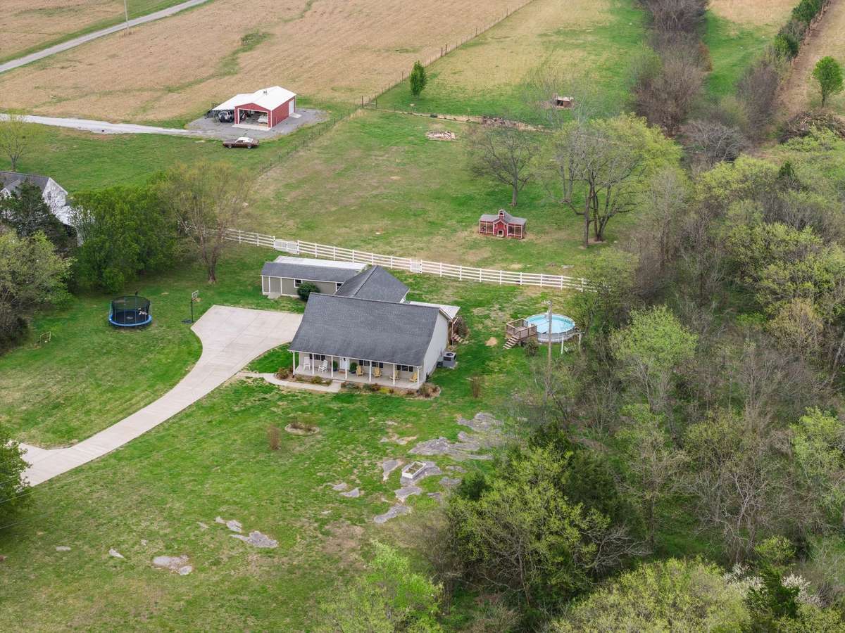 Aerial view highlighting the yard and outdoor features.