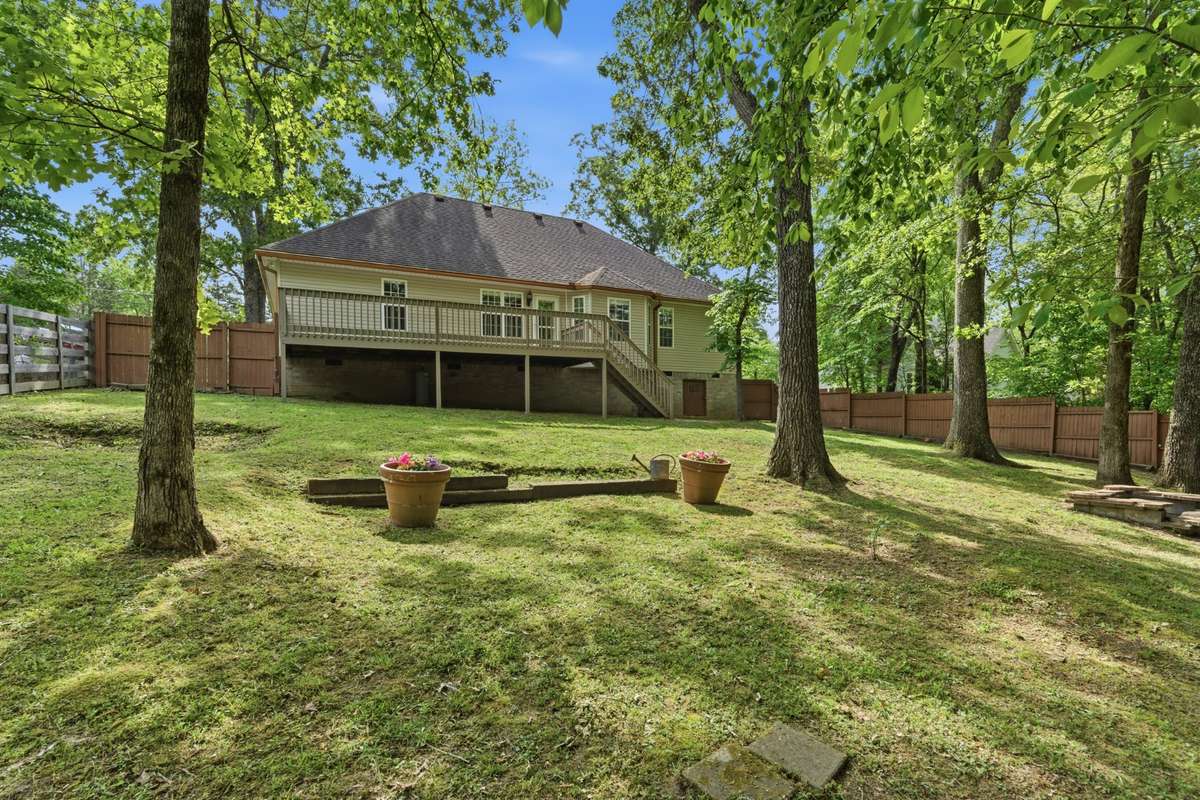 Private, tree-lined backyard retreat with deck space and plenty of room to relax, entertain, or just simply enjoy nature