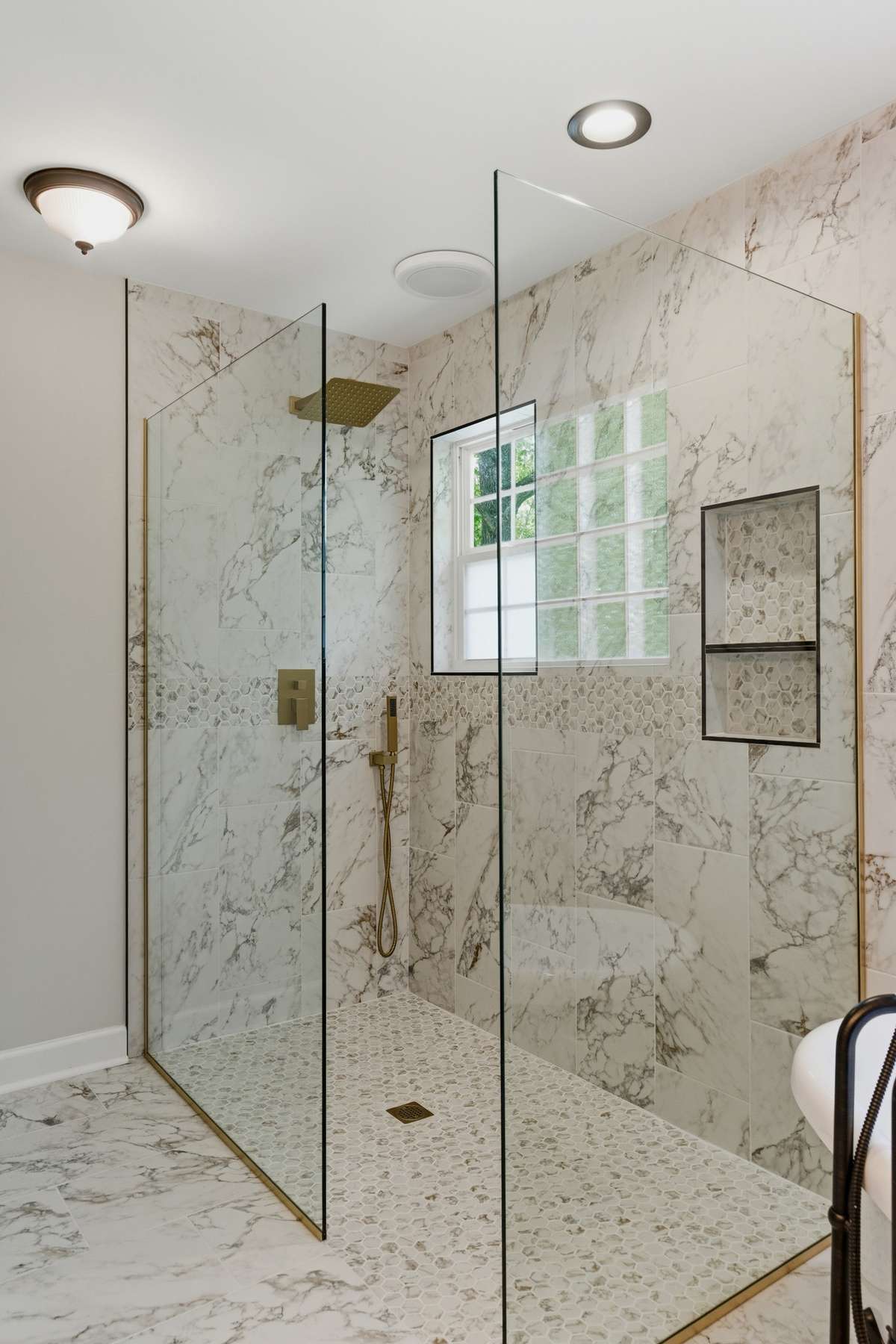 Spa-like shower with elegant tile work, sleep glass enclosure and great modern finishes