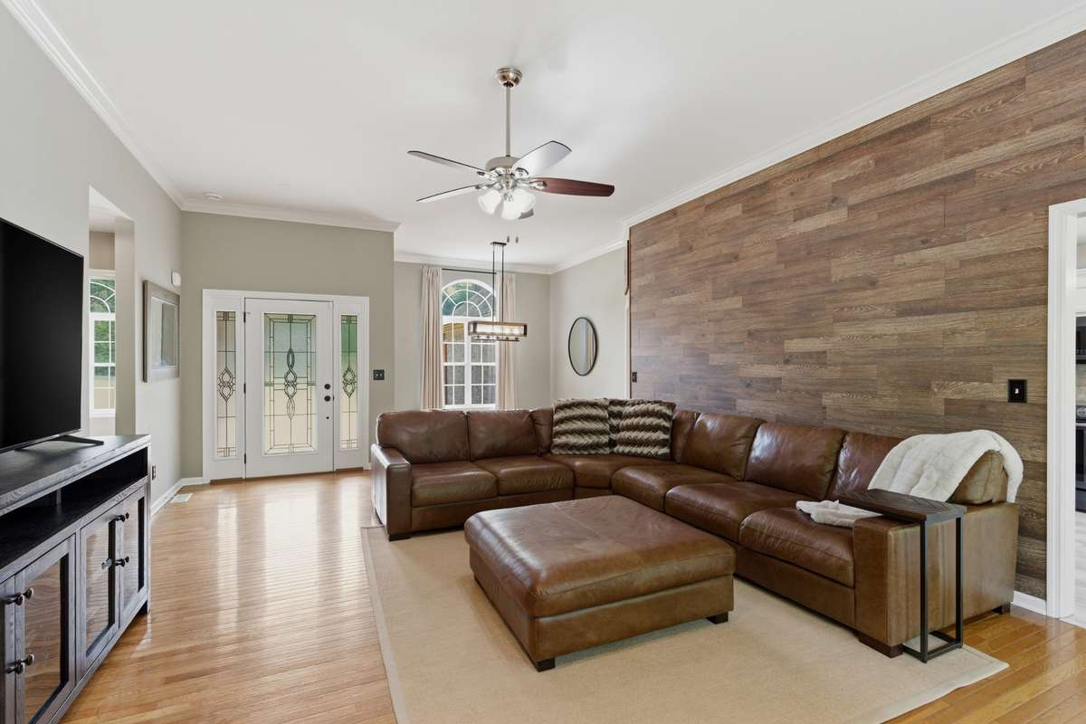Warm and inviting living space the features natural light and a wood accent all that make it perfect for cozy nights or entertaining guests