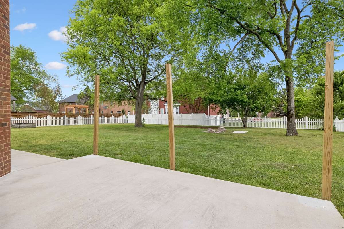 Patio on the rear of the home! Great place to relax or barbecue! The posts can be used to hang outdoor light strand if desired!