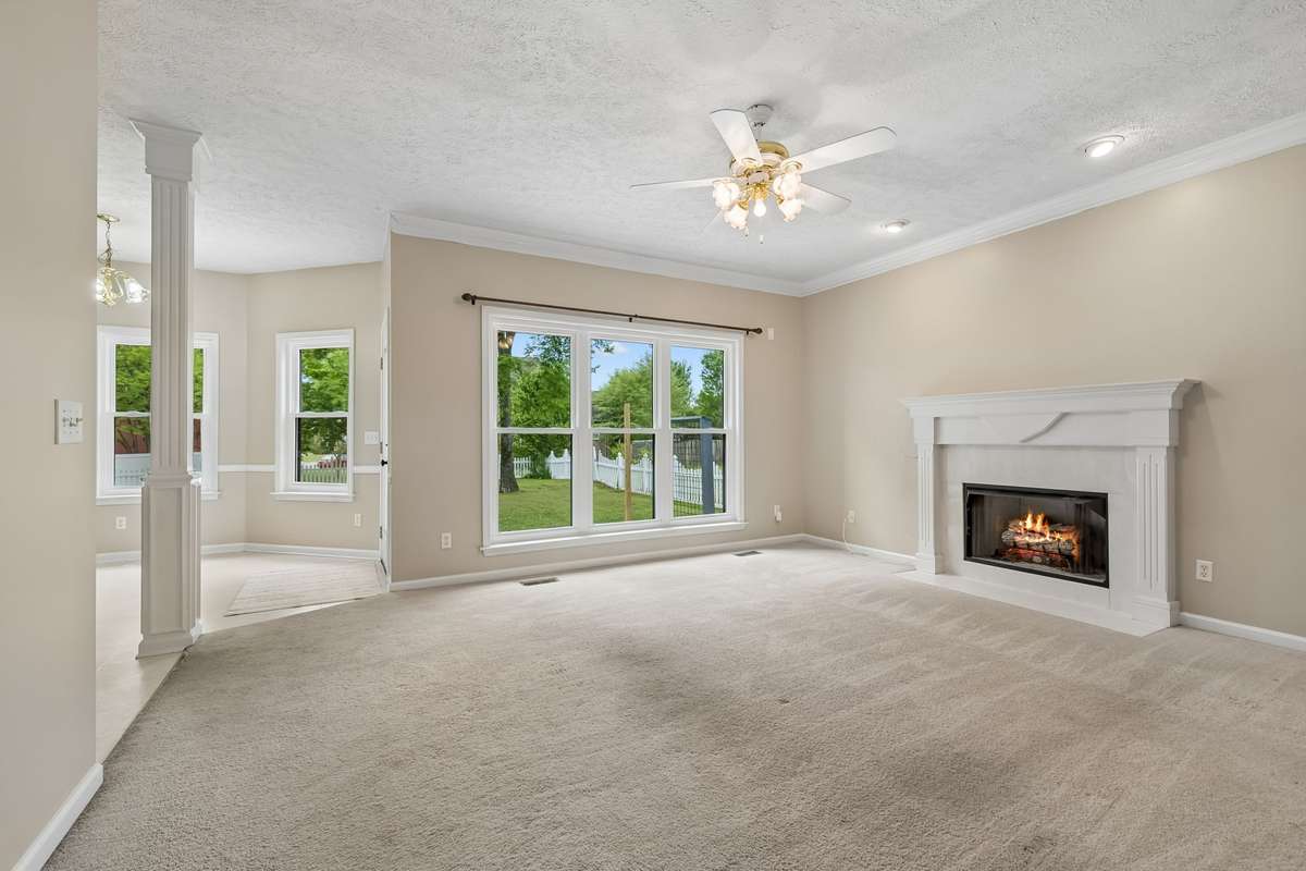The Living Room adjoins the Kitchen and Eat-In area and overlooks the back yard.  Enjoy this natural gas Fireplace! As an fyi, the carpet in this home is original and needs replacement. This is an opportunity to make your own choices on flooring!