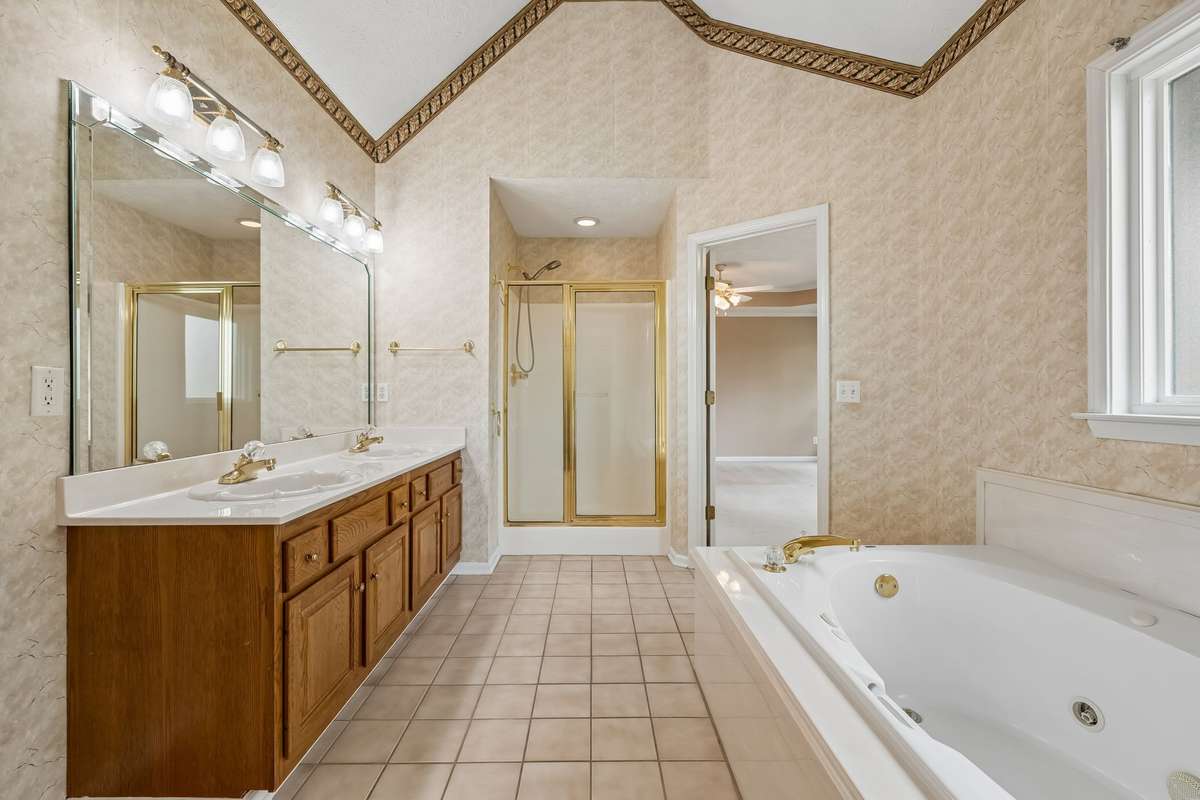 There is also a walk-in shower and tall ceilings in this area, also tile flooring!