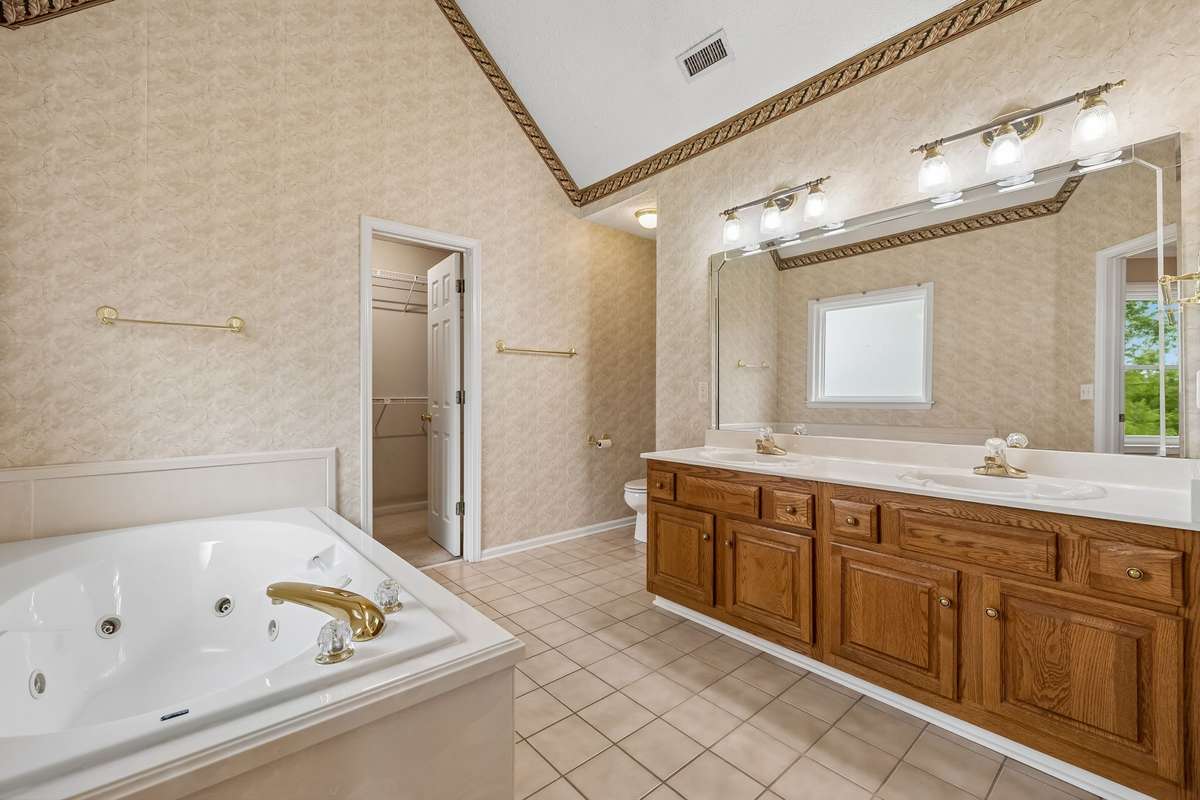 The full Bath with jetted tub and vanity with two sinks for the Primary Bedroom!