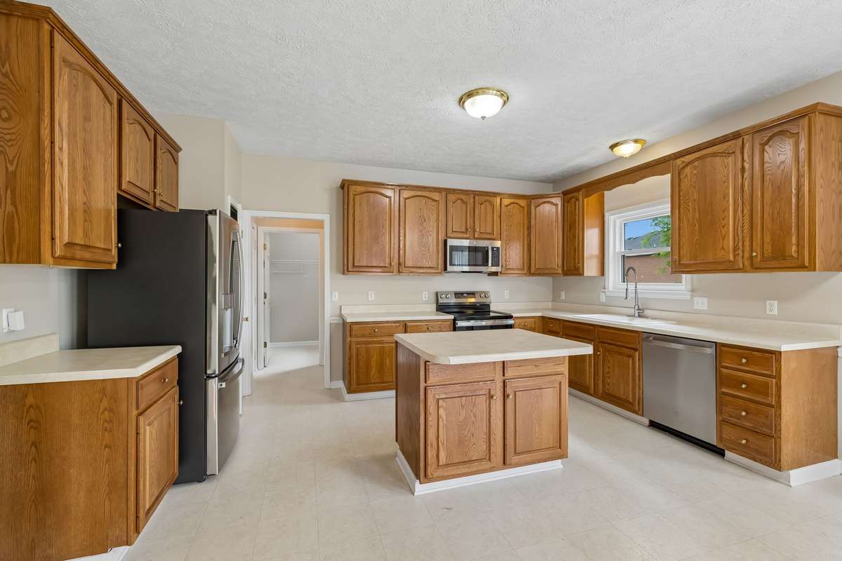 The Kitchen offers 4' cabinets for lots of storage ability! Floors are vinyl in this area! And, the new appliances all remain!