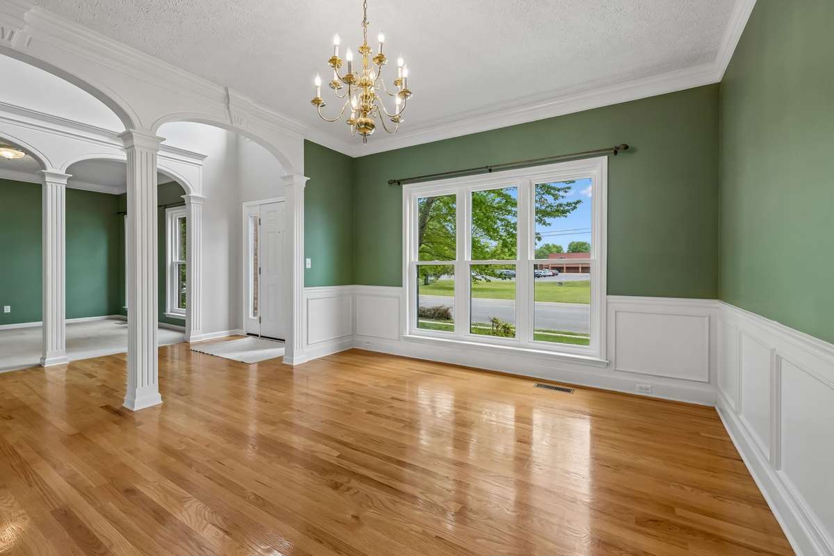One of the highlights is the Foyer entrance which is 2-stories, the pillars as you enter, the gleaming hardwood flooring in the Dining Room and the wainscotting trim!