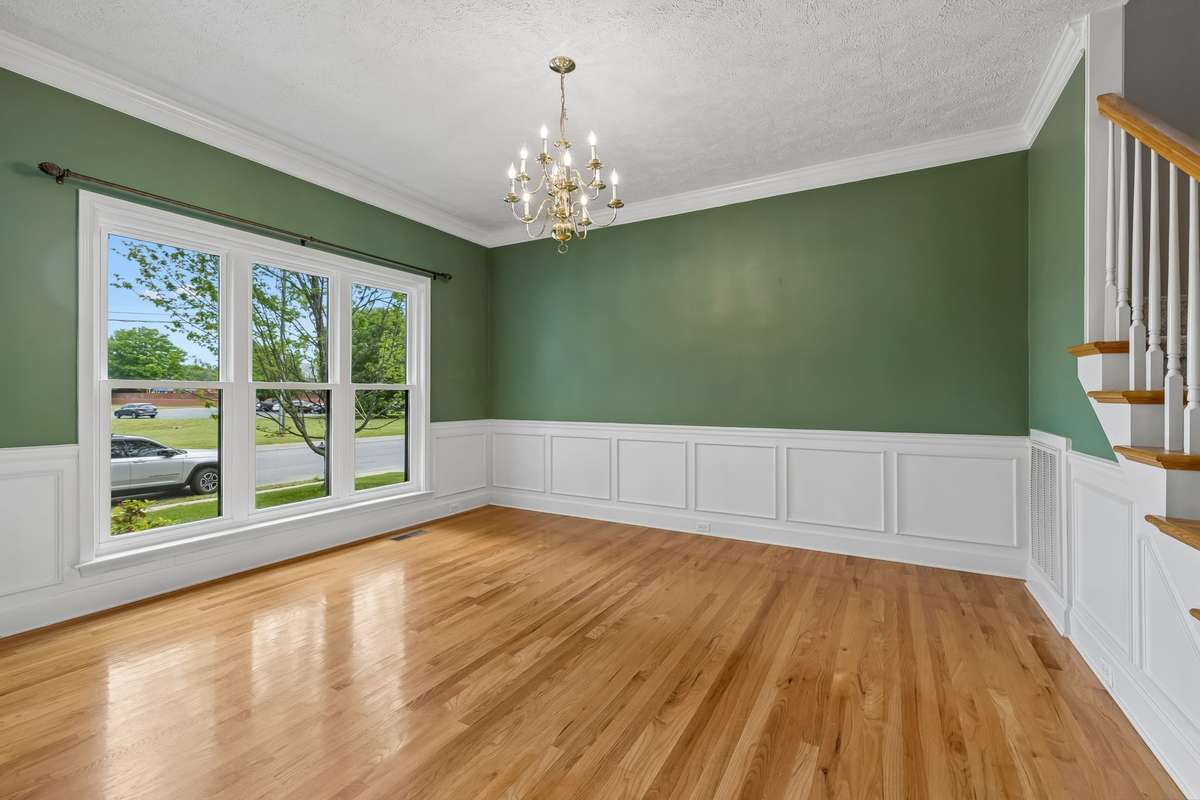 The formal Dining Room with beautiful hardwood flooring! This home has all new Pella windows throughout - 30 windows to be exact!
