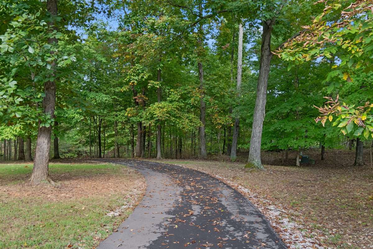 Recently paved driveway leads to the secluded setting off the road
