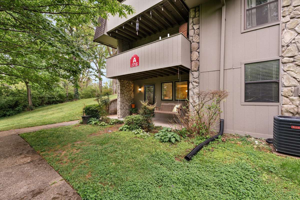 1st floor end unit with charming porch swing!