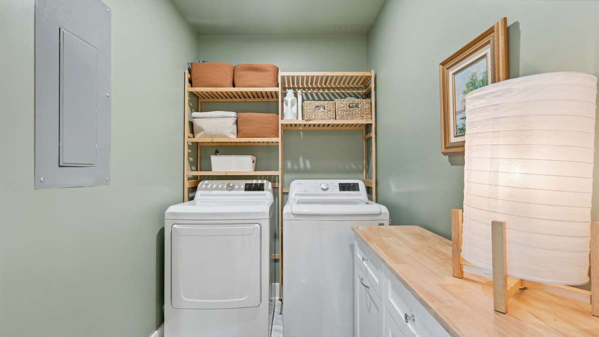 Separate laundry room located off the dining area near the primary bedroom, offers plenty of space for additional storage