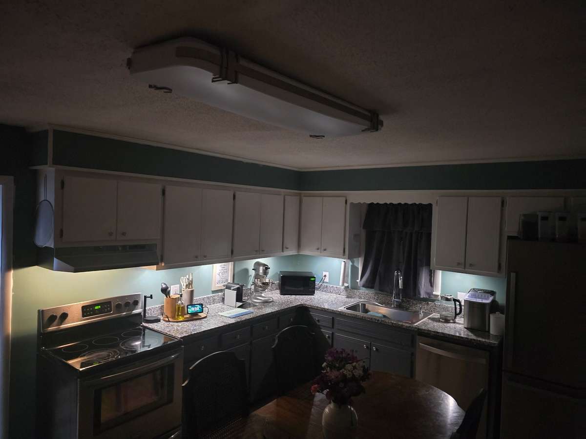 View of under cabinet lights on at night.