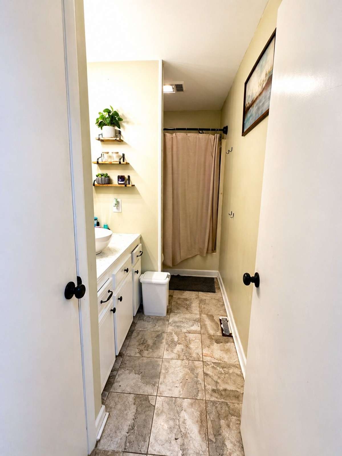 Upstairs bathroom has marble tile flooring