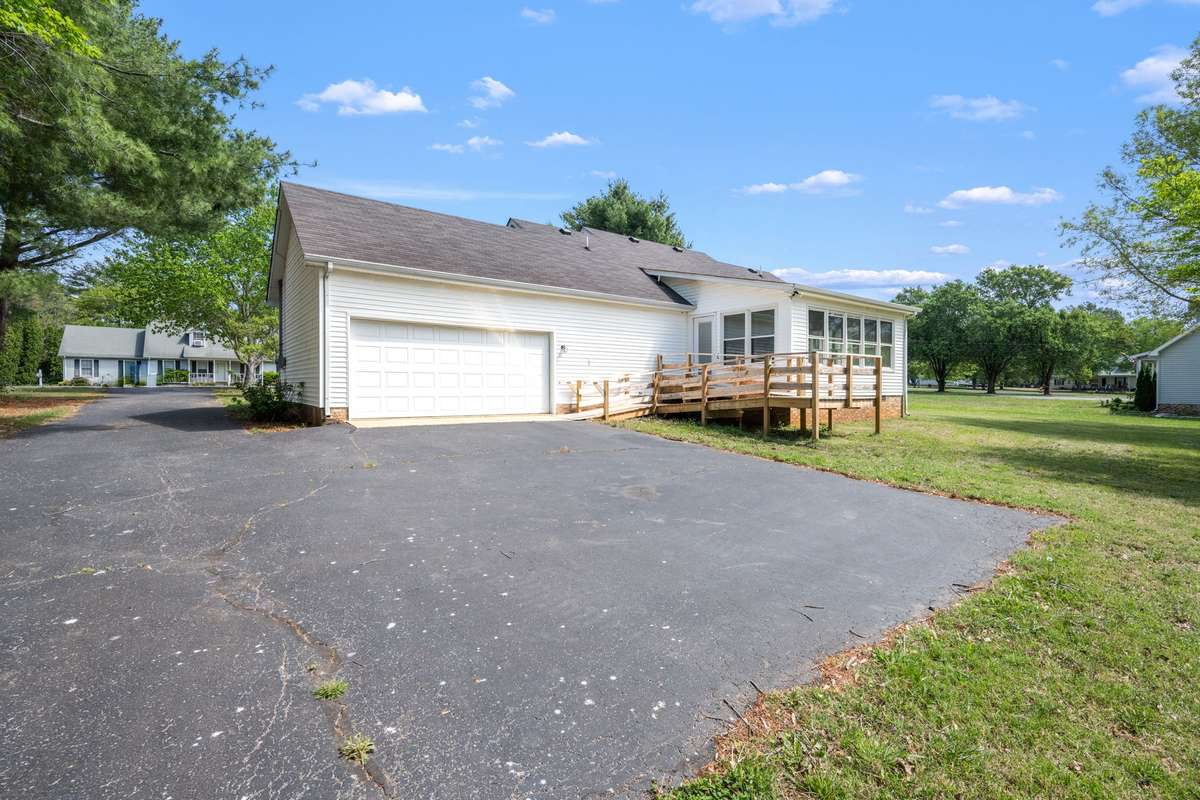 Handicap accessible ramp off the back sunroom.