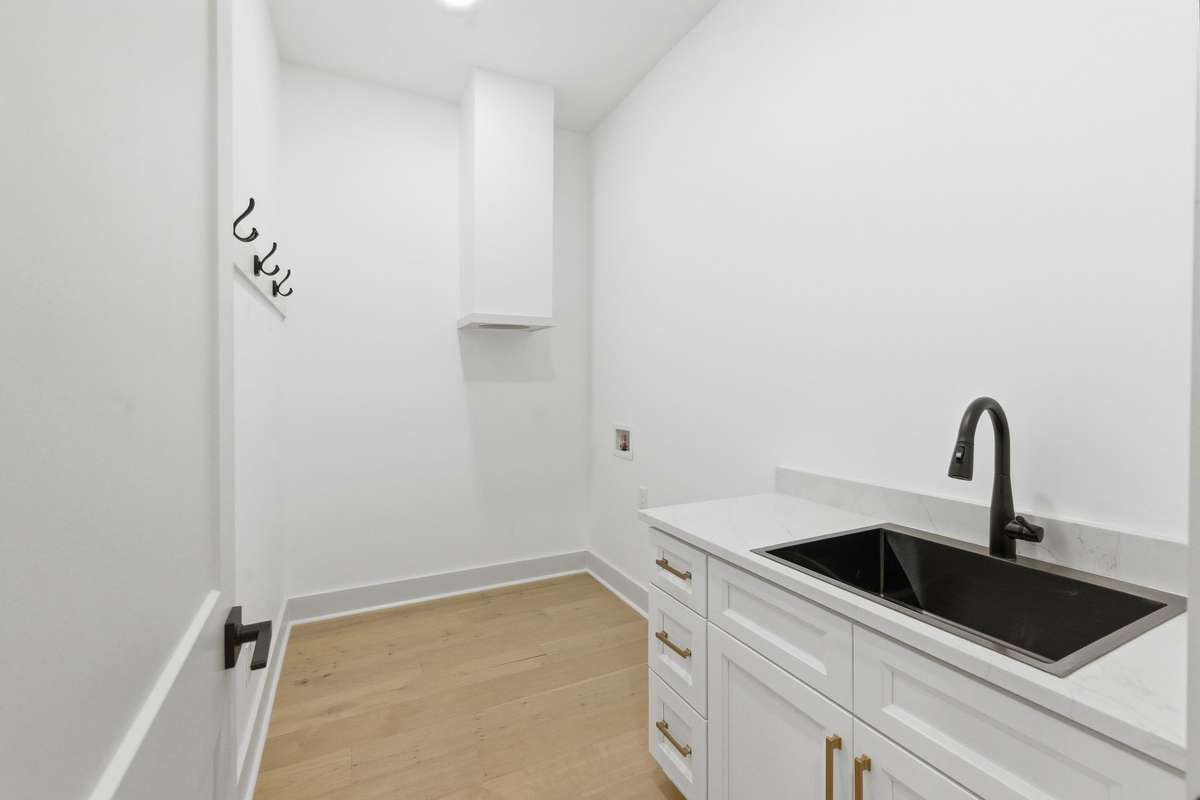 Utility room on lower level featuring a convenient laundry chute