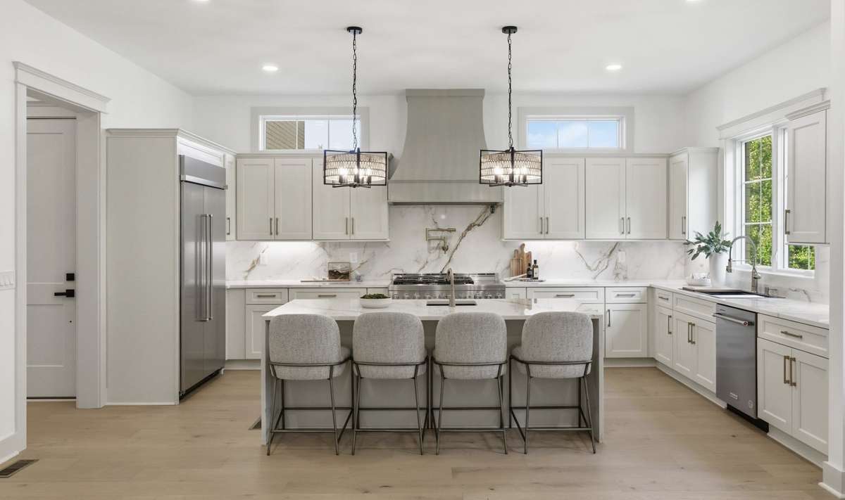 Bright open kitchen with professional stainless steel appliance package
