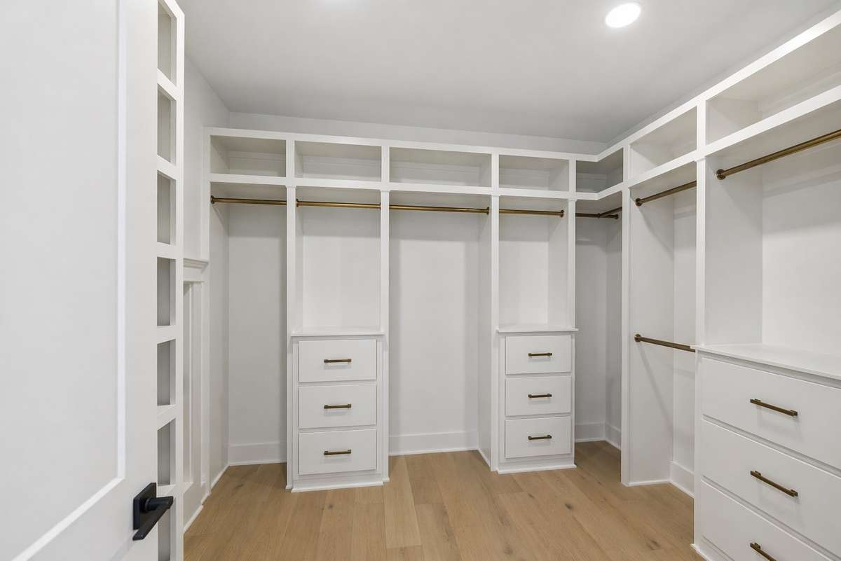 Primary upstairs walk-in closet. Photo digitally enhanced with AI.