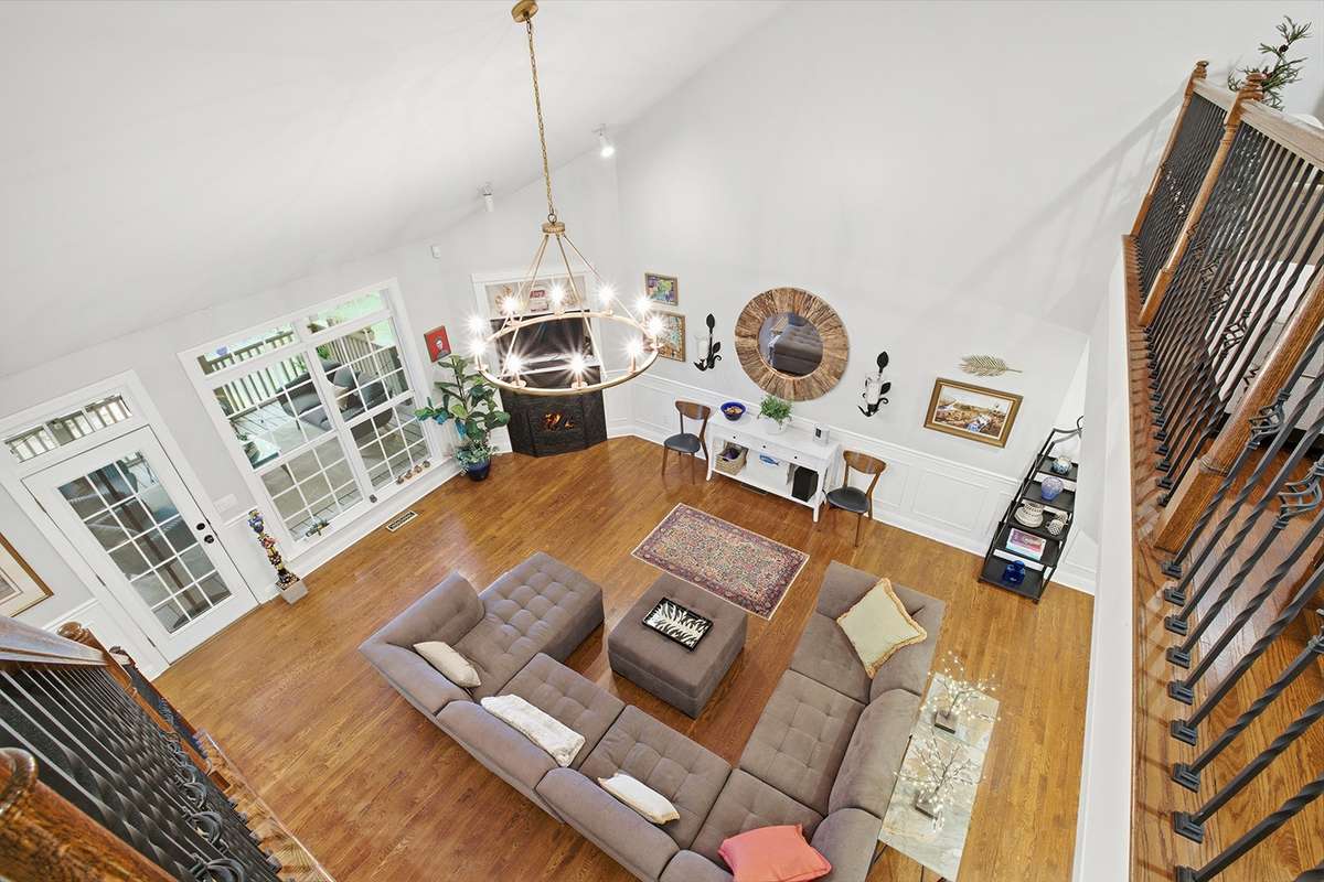 Recessed lighting, beautiful chandelier, big windows fill this space with light