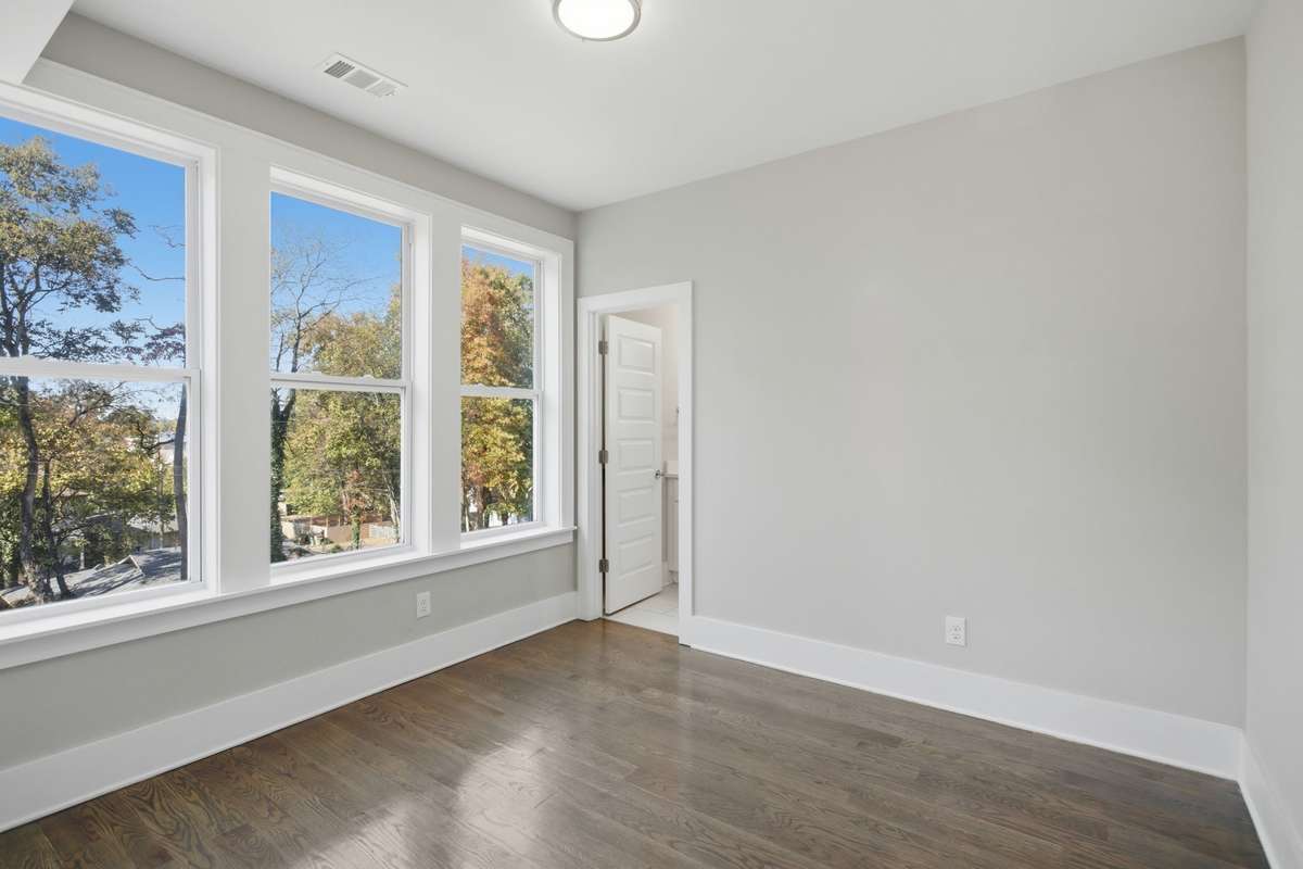 Bedroom three is on the third level next to the primary suite facing the front of the home. All three bedrooms offering generous storage and thoughtful design throughout.