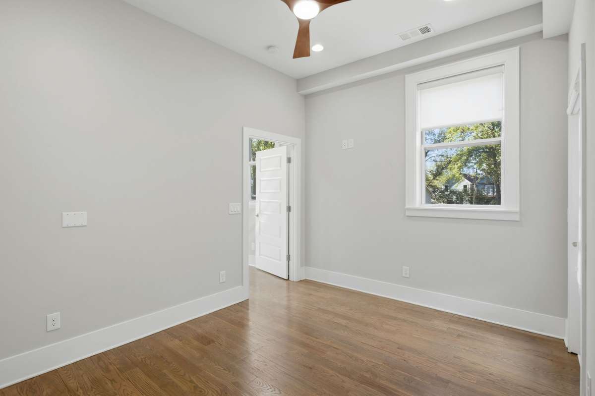 Bedroom three with beautiful hardwood floors, walk-in closet and an abundance of natural light.