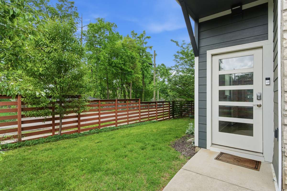 Front entry way with fenced yard and lovely green space.