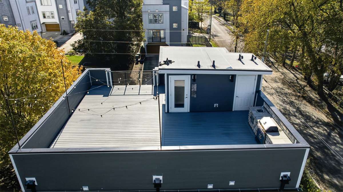 The rooftop features a membrane system, which is a durable, waterproof surface designed to protect the roof deck underneath while also creating a usable outdoor space. Its ideal because it seals the surface and helps prevent water intrusion.