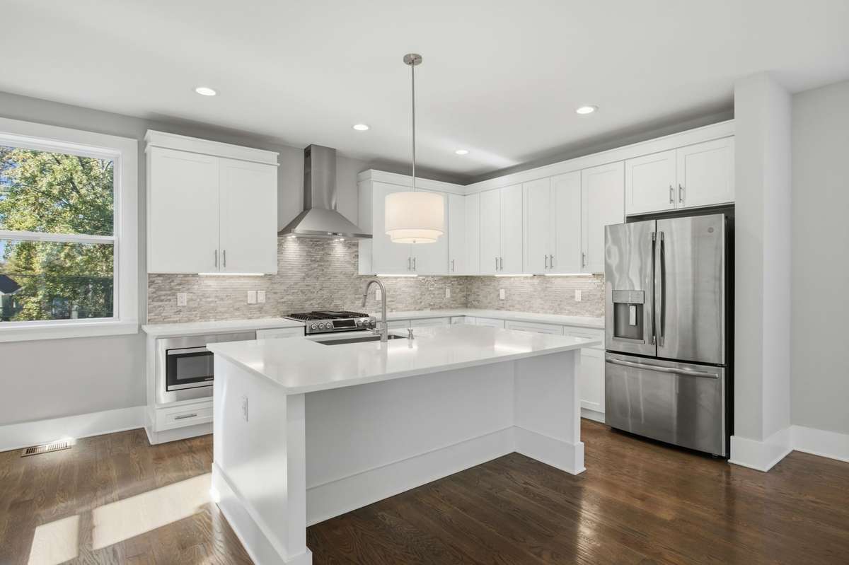 Granite countertops with a classic tile backsplash anchor the kitchen with both beauty and durability.