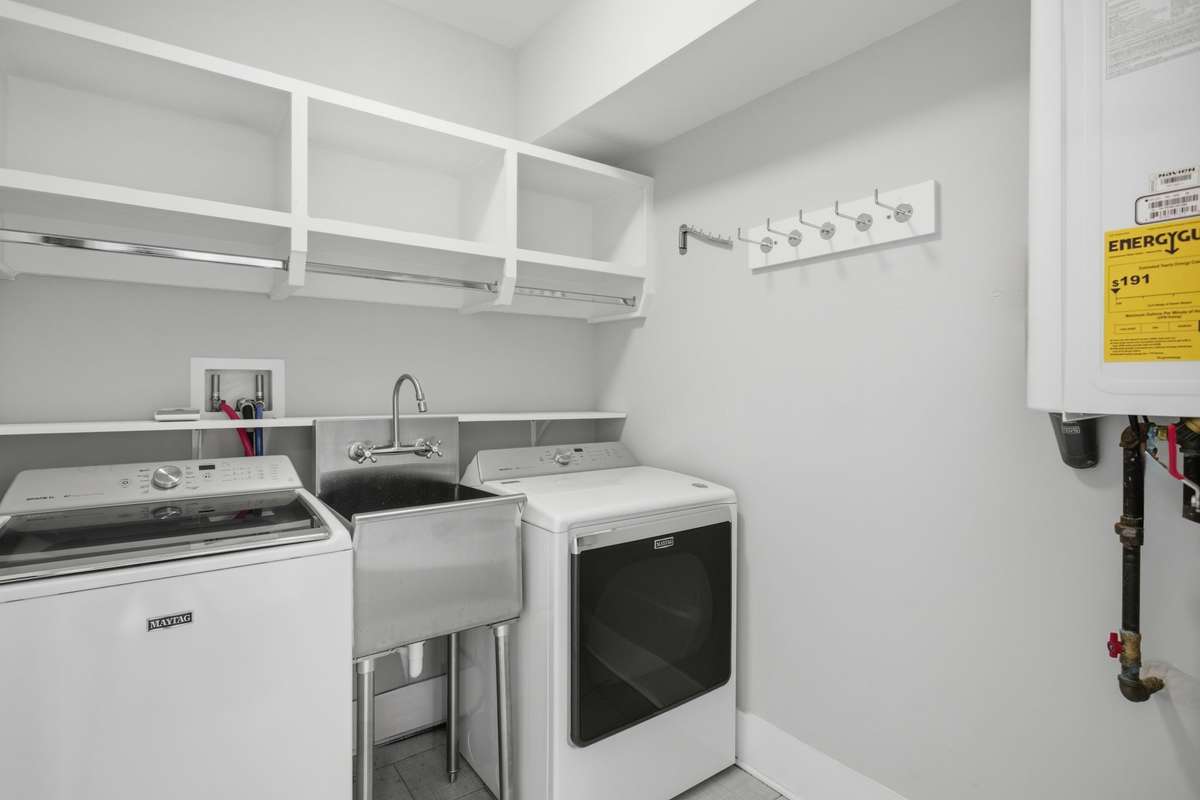 Washer and Dryer located on level 3 between the Primary suite and Bedroom three. Built in sink is a major bonus. Washer & Dryer to remain.