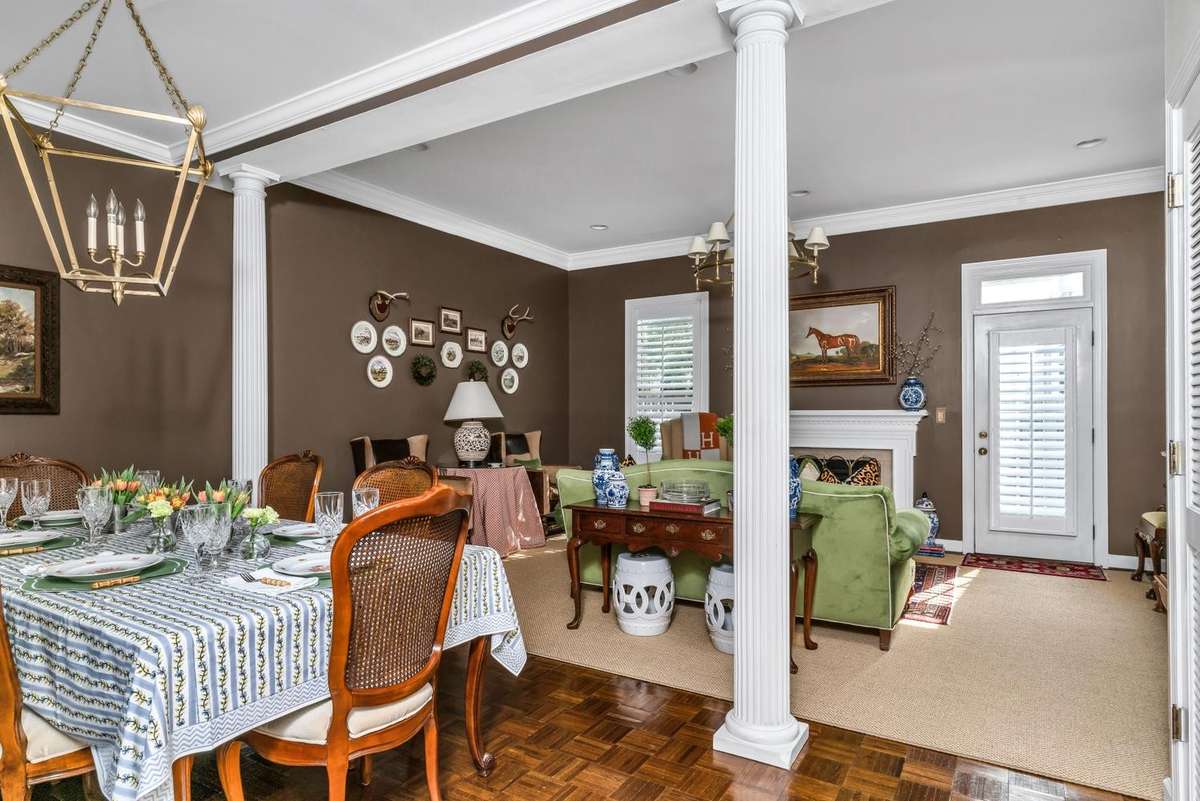 Parquet hardwood floors + columns are the perfect complements to this classically designed home.