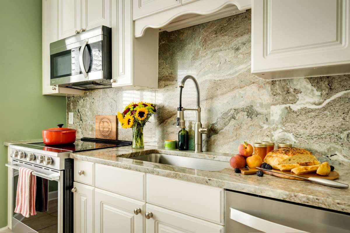 Gorgeous countertops, backsplash, stainless steel appliances + vast cabinetry.